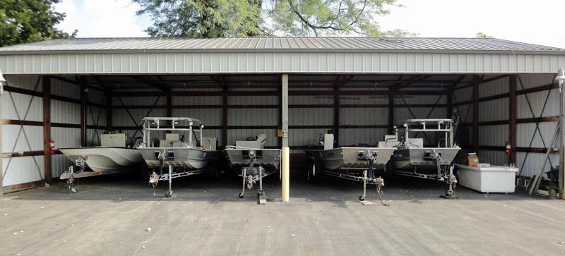 AEL boat barn with 5 aluminum welded general boats on trailers