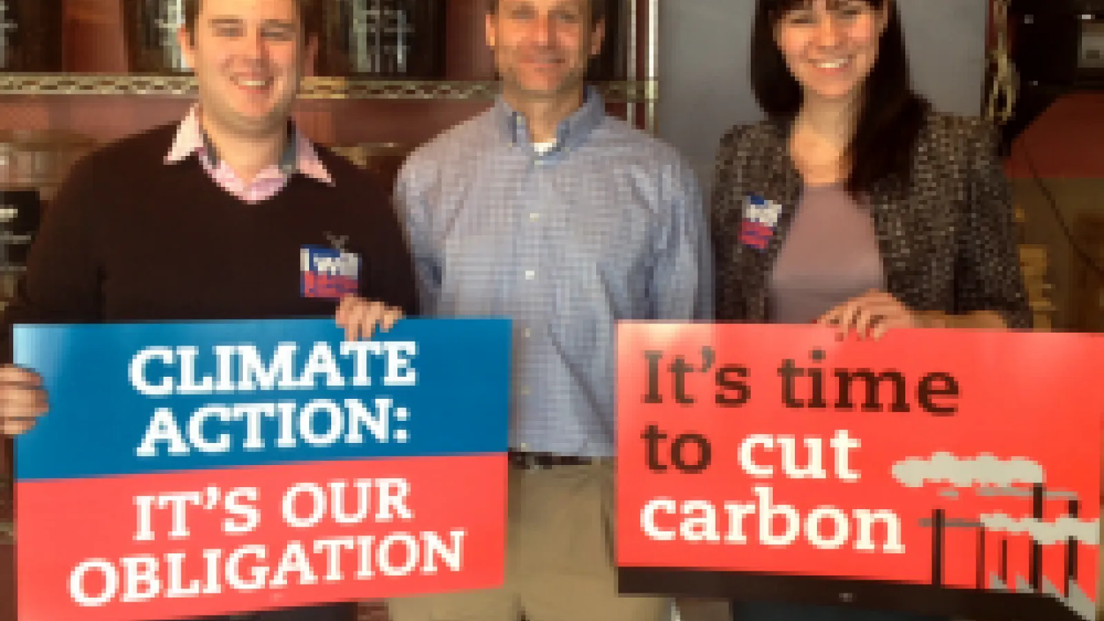 Stu Ludsin and two others holding posters about climate change