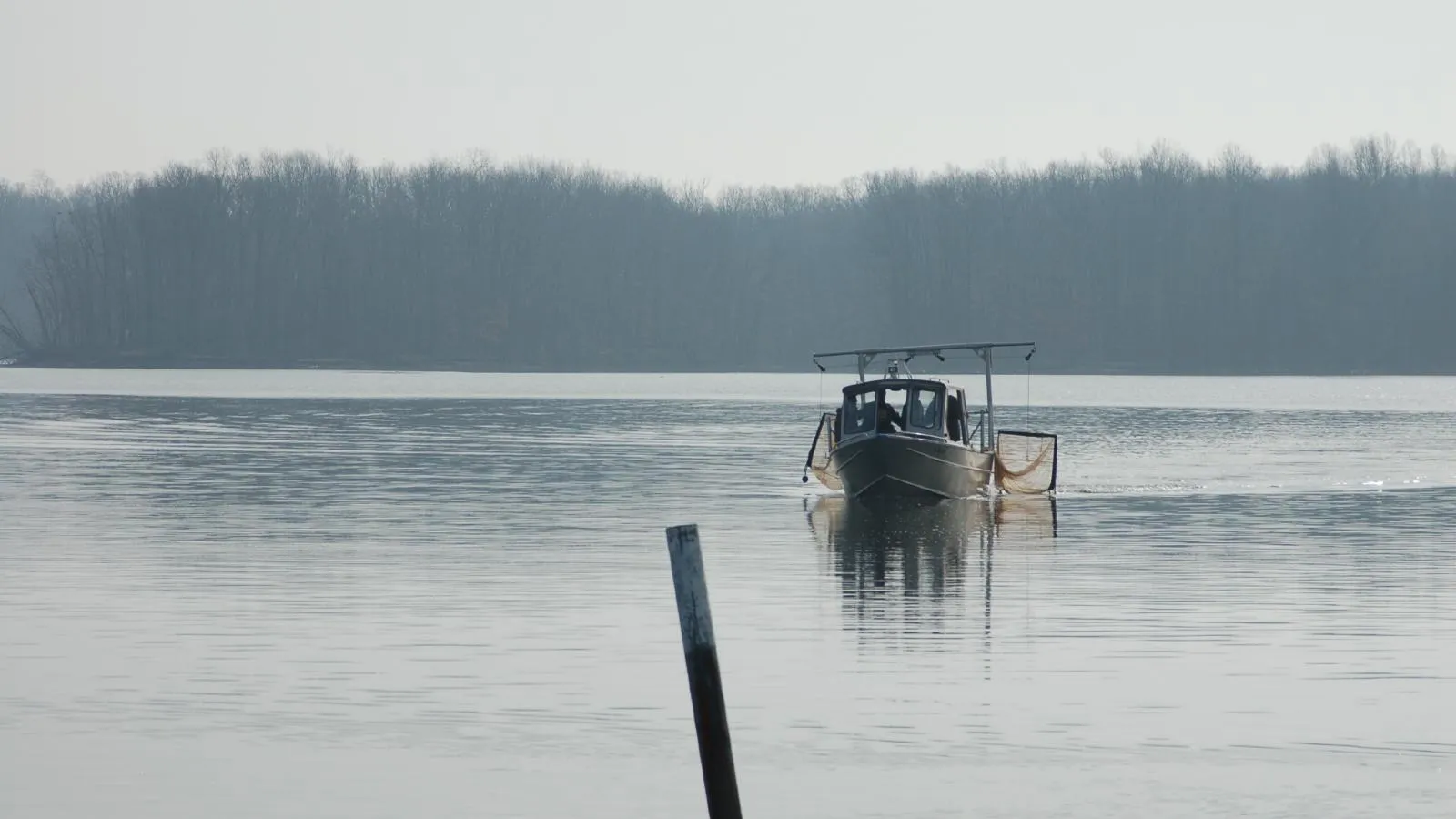 Boat with trawl on reservoir