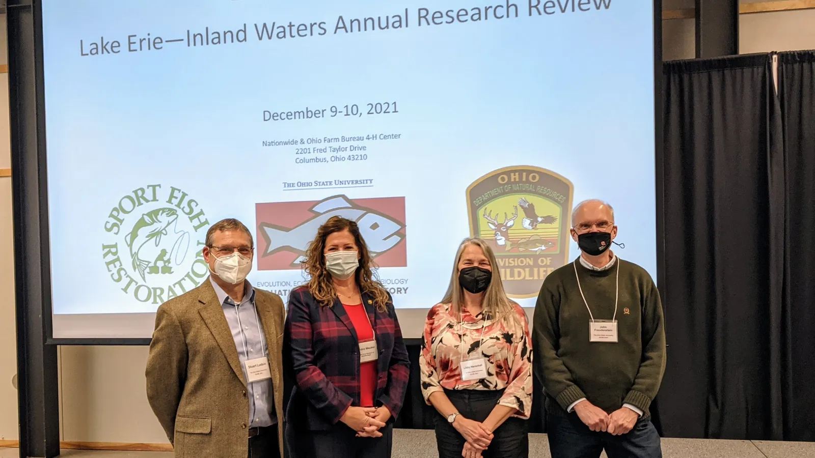 Dr. Ludsin, Kendra Wecker, Dr. Marschall, and Dean Freudenstein in front of the Research Review title slide