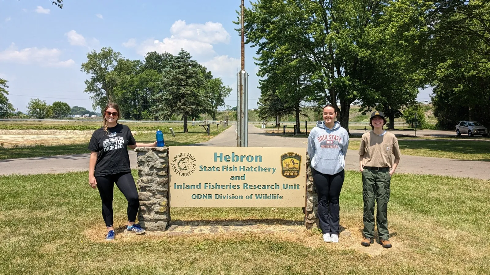 REU Students by IFRE sign