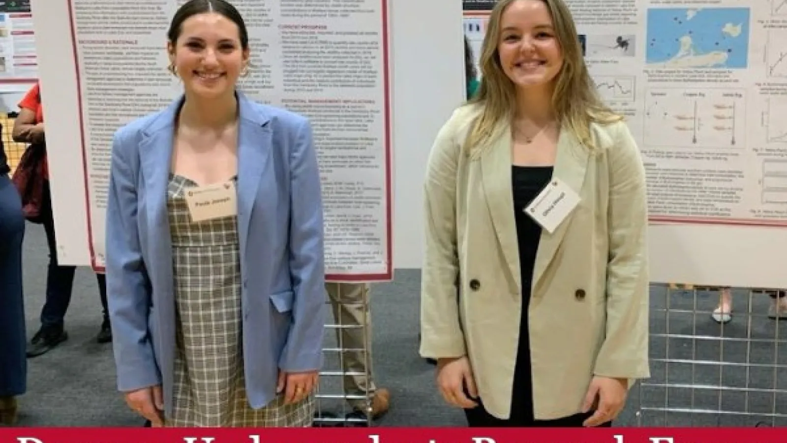 Paula Joseph and Olivia Houpt in front of their posters