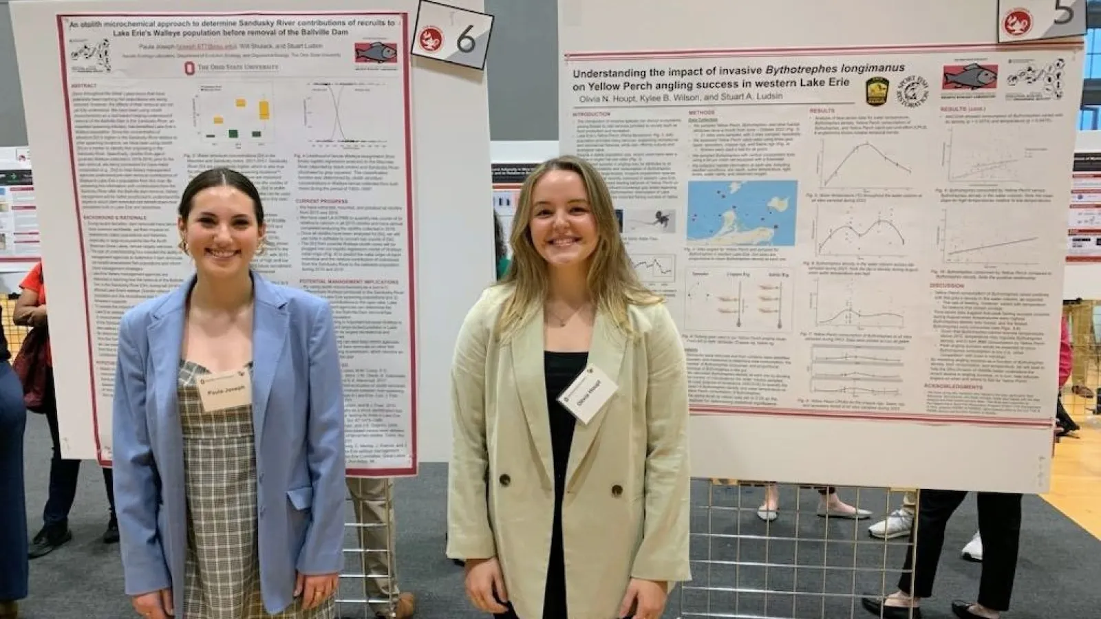 Paula Joseph and Olivia Houpt in front of their posters