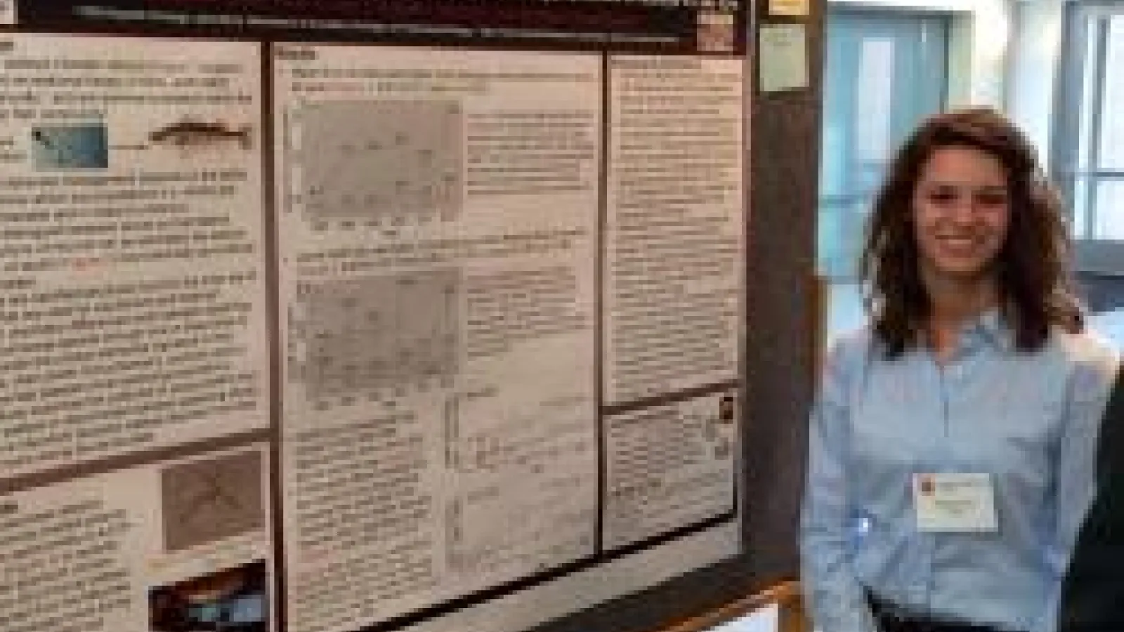 Morgan Corey in front of her poster