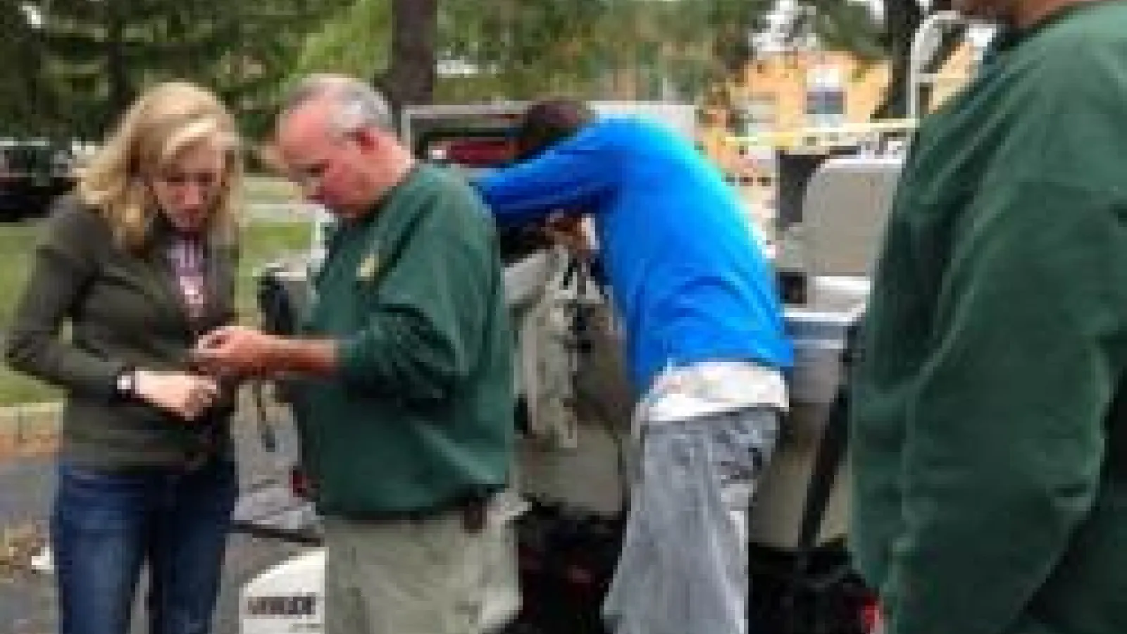 DOW and AEL staff looking at boat parts