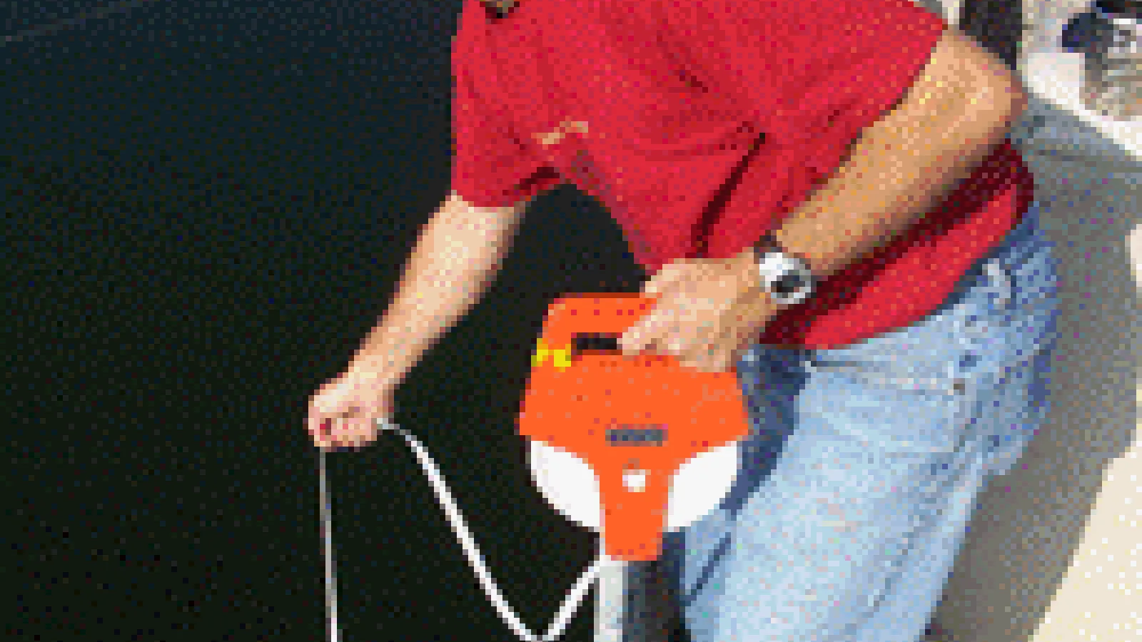 Dr. Michael Vanni holds a tool used for checking water depth