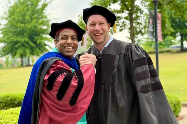Nayan Mallick and Josh Stone in academic regalia
