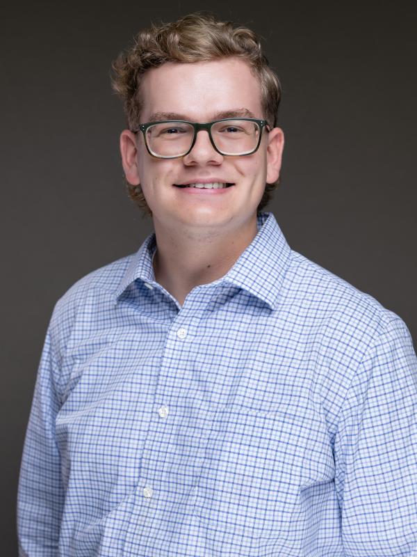 Jacob Bentley in a white and blue button down shirt.