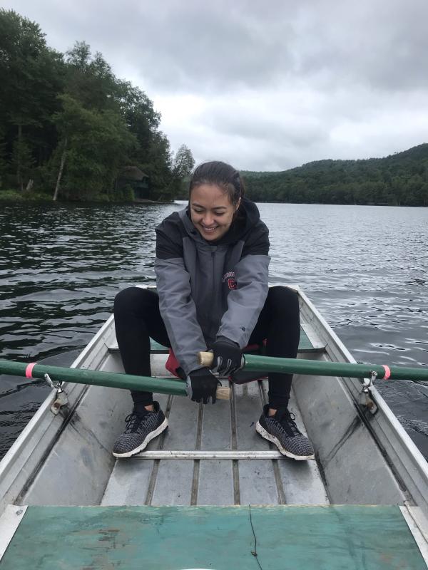 Demetra rowing a rowboat in a lake