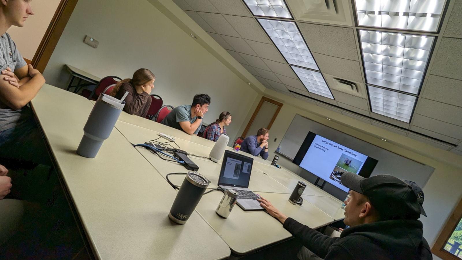 REU Students and advisors watching a presentation