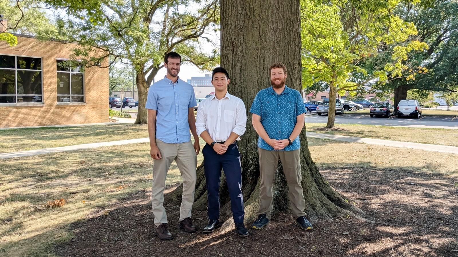 Jeremy Pritt, Hwan Chen, and Casey Pennock in front of a tree