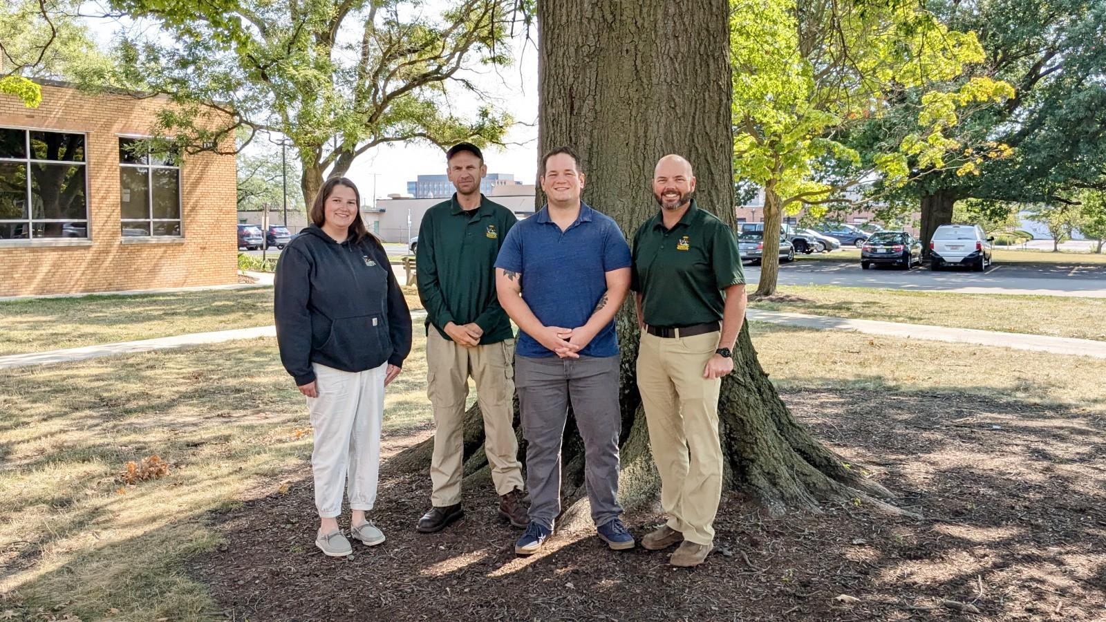 Taylor Hunkins, Steve Tyszko, Mike Figueroa, and Joe Conroy in front of a tree