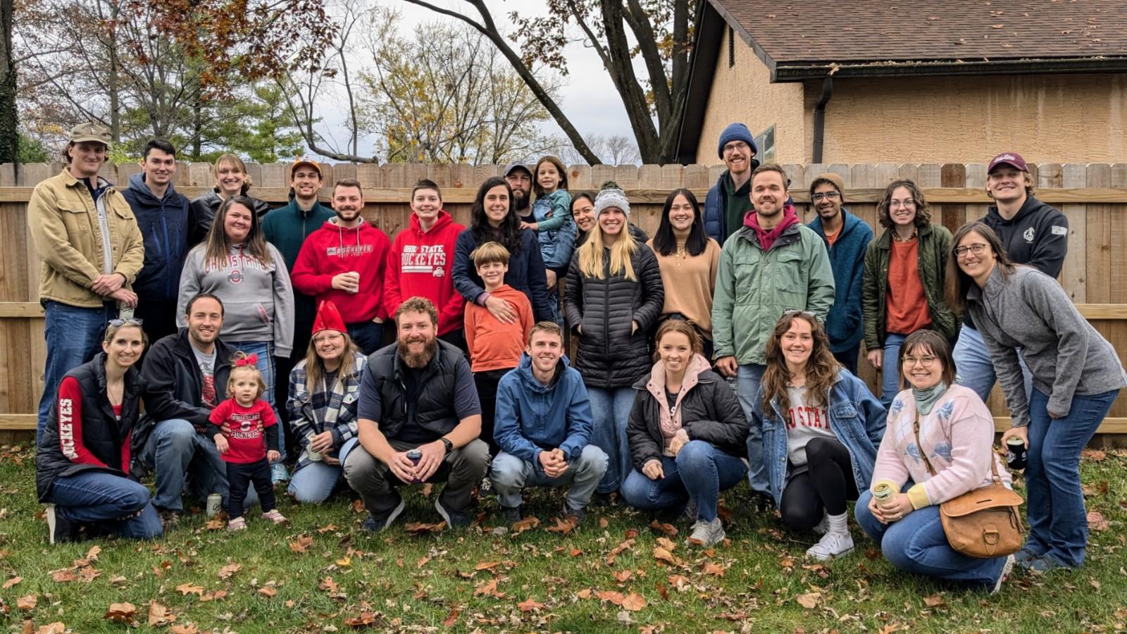 Group photo of AELers at the chili cookoff in a backyard