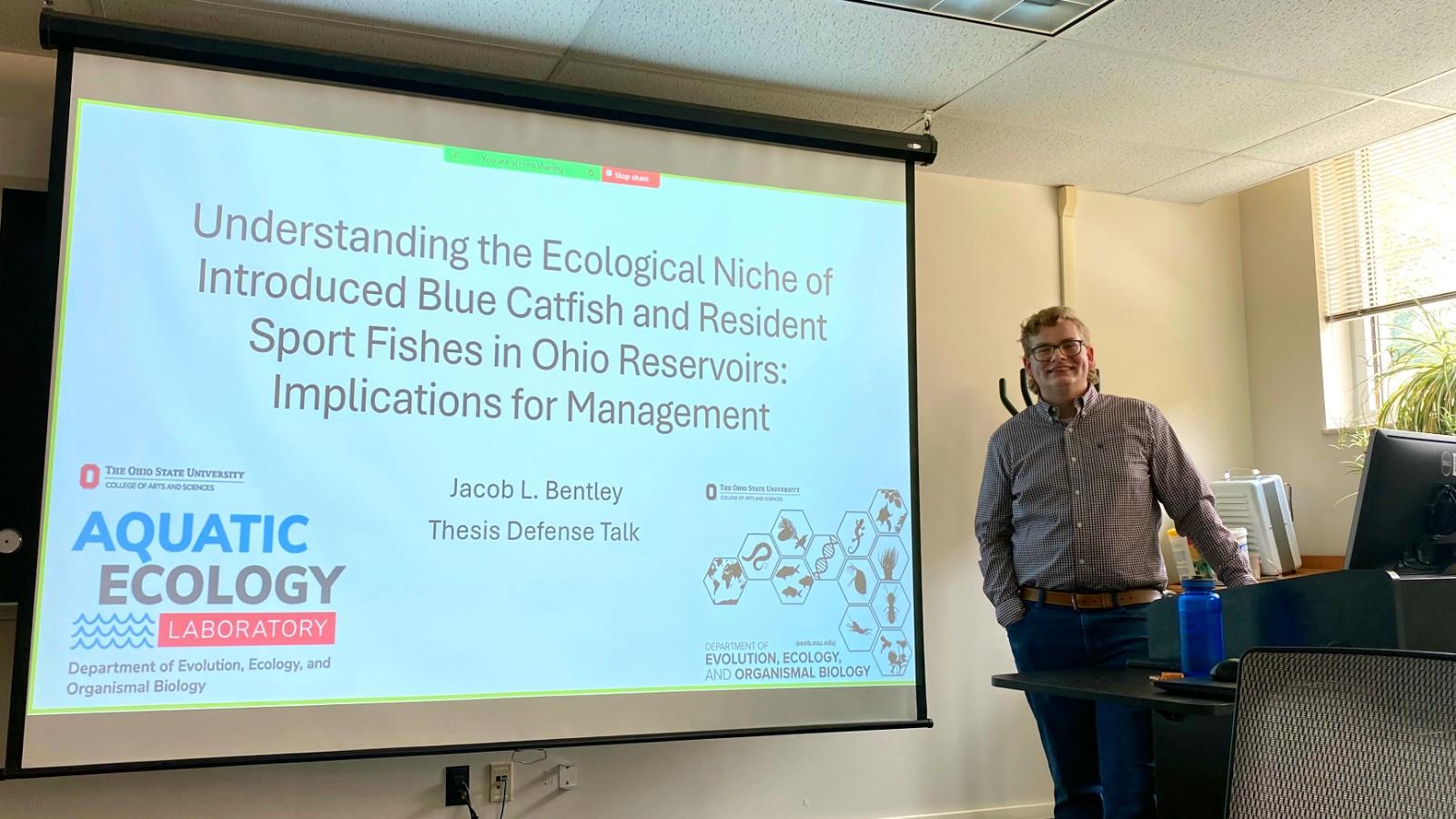 Jacob Bentley next to his title slide 