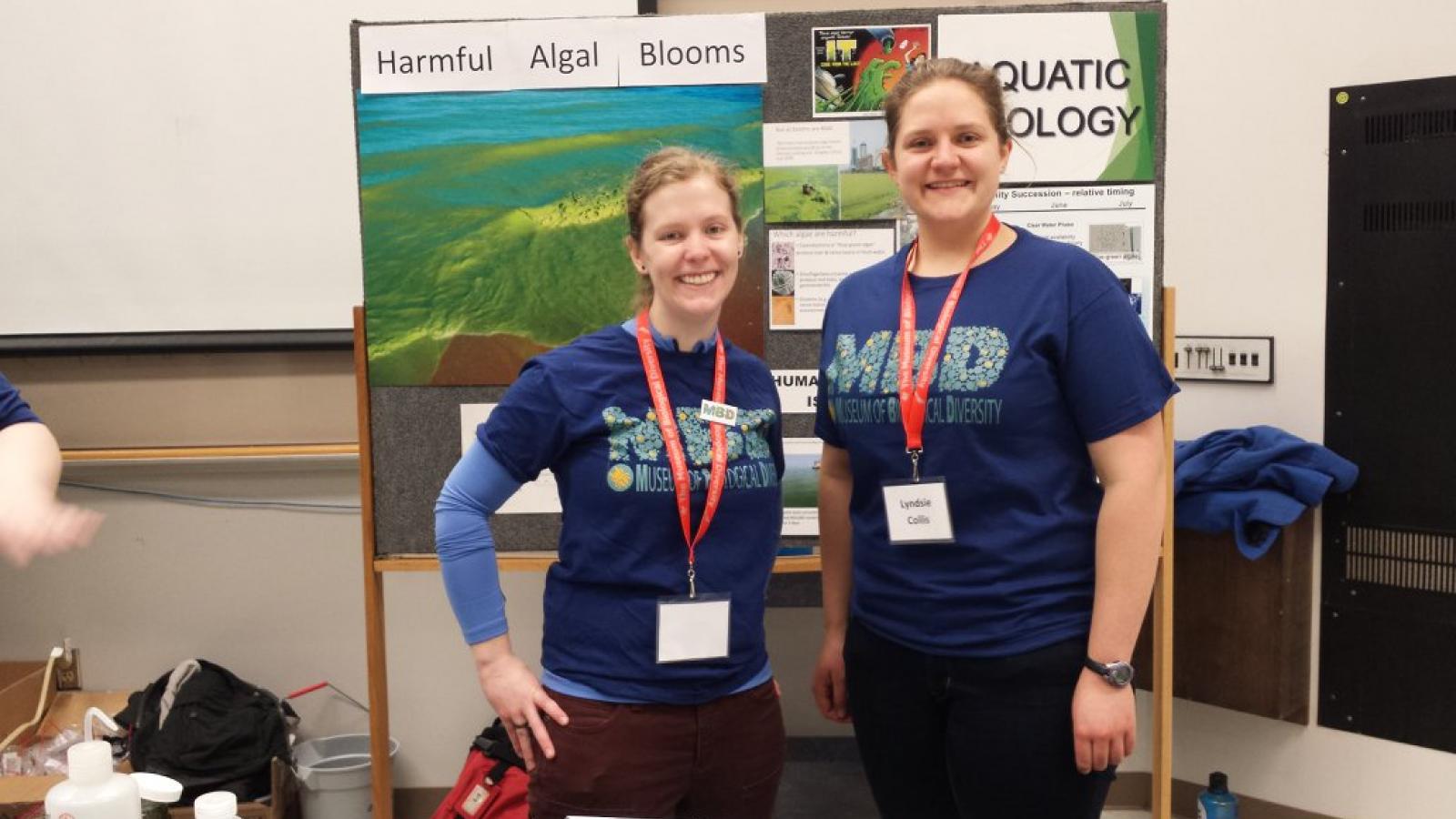 Zoe Almeida and Lyndsie Collis stand in front of the AEL display at the museum open house